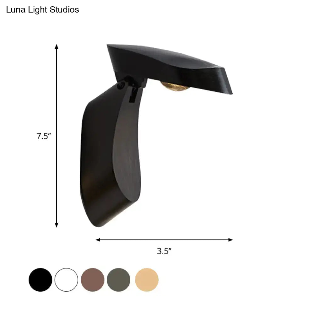 Black matte-finished metal wall light with sleek curved design in modern gold metal fixture for bedroom bedside use