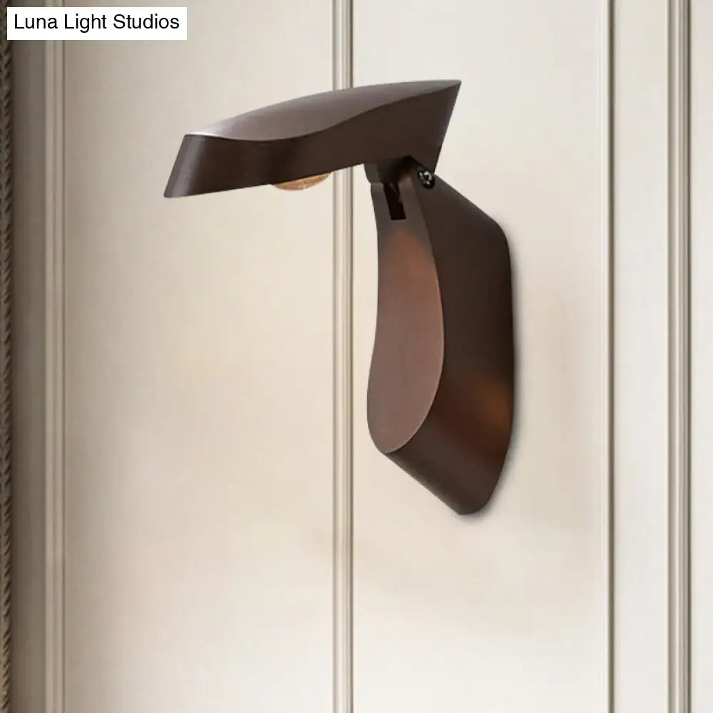 Modern bronze-finished metal wall light with sleek sculptural curves for bedroom bedside lighting fixture
