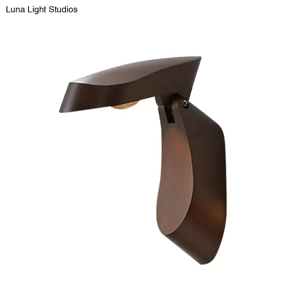 Bronze-finished metal wall light with sleek modern curves and minimalist design for bedside bedroom use