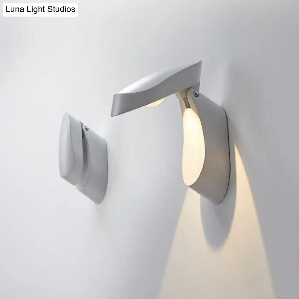 Modern gold metal wall light bedside fixture with sleek angular design and warm ambient lighting for bedroom