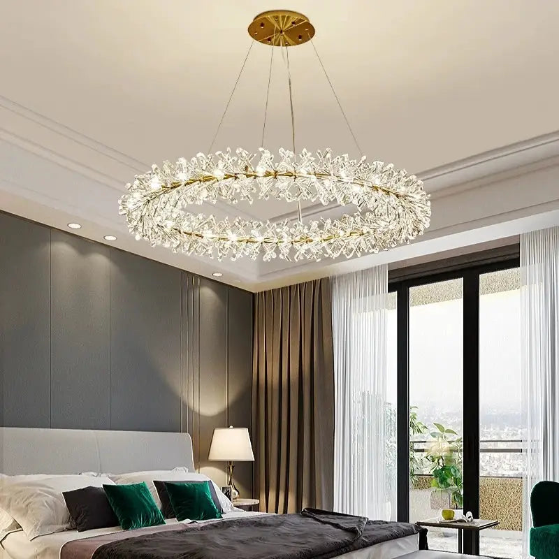 Modern gold metal wire chandelier with crystal elements in a circular design for dining room lighting