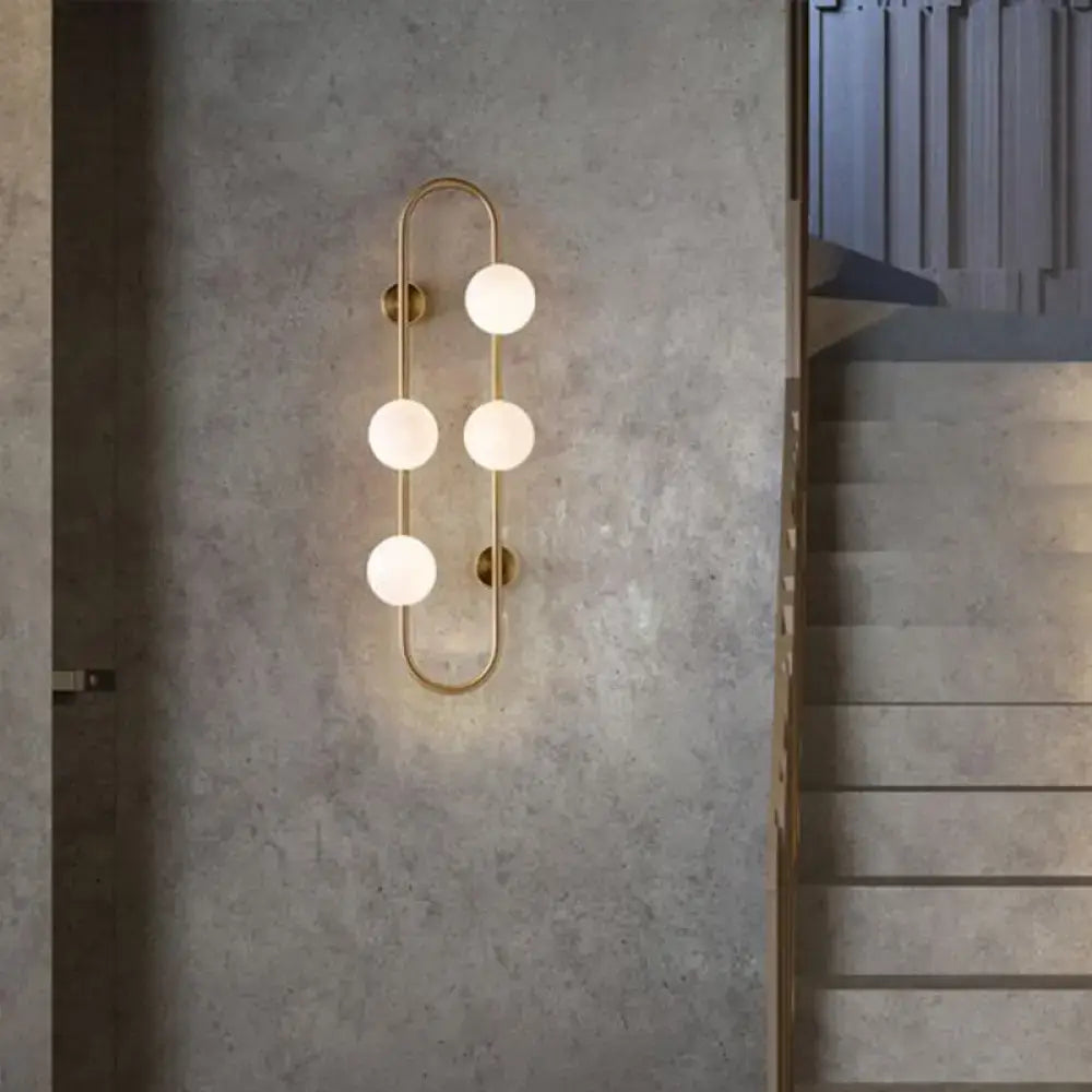 Modern gold wall light with five frosted milky glass shade globes in a vertical curved design for bedroom use