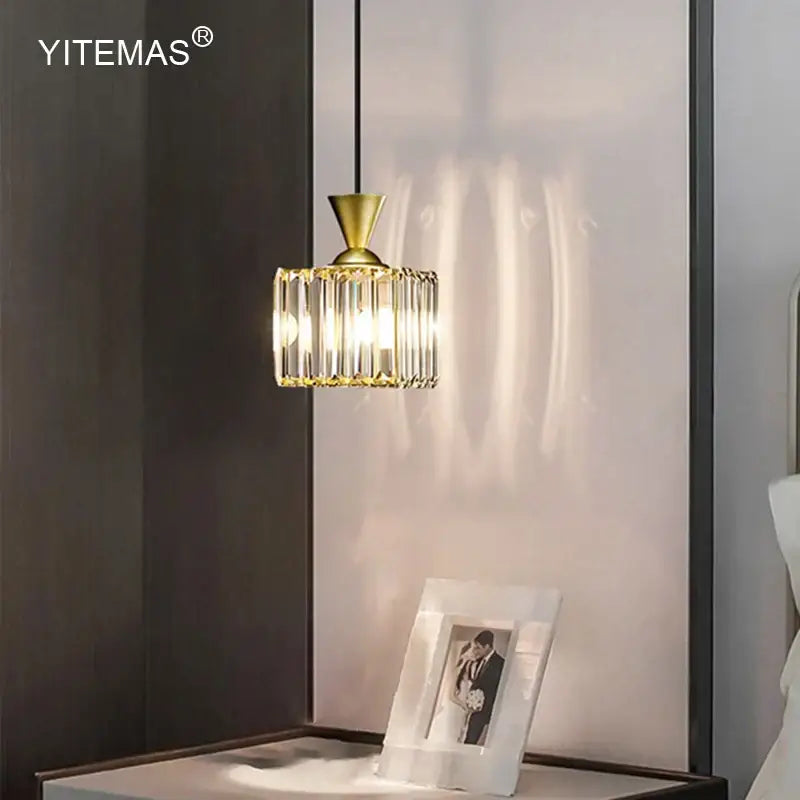 Modern gold mini crystal pendant light with cylindrical crystal cage design featuring vertical glass rods for bedroom decorbites gold mini