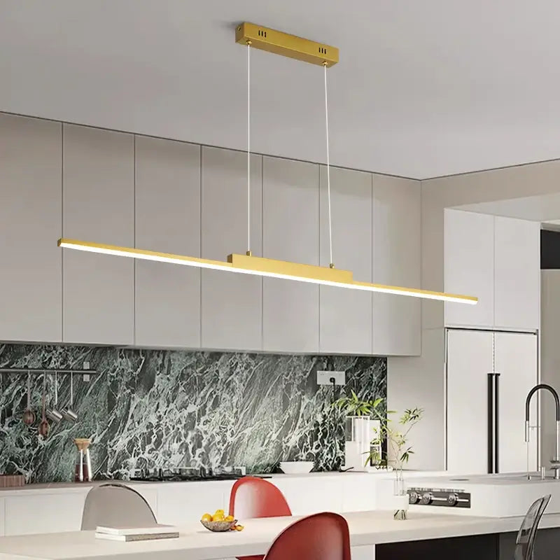 Modern gold minimalist dimmable led pendant light with sleek rectangular design hanging above kitchen island as light source
