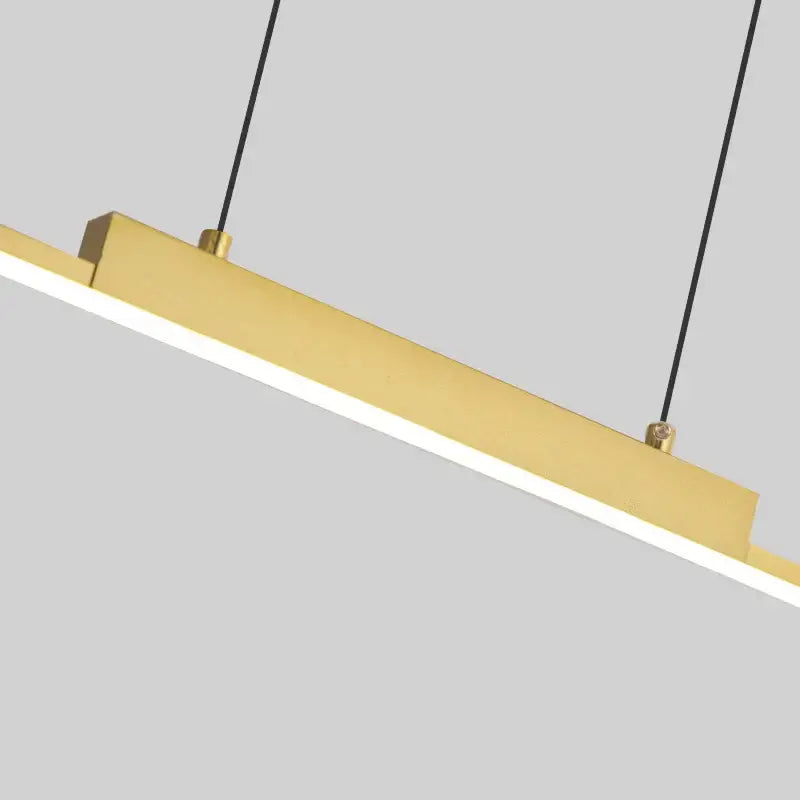 Modern gold rectangular pendant light with sleek black cords featuring dimmable led light source for dining room