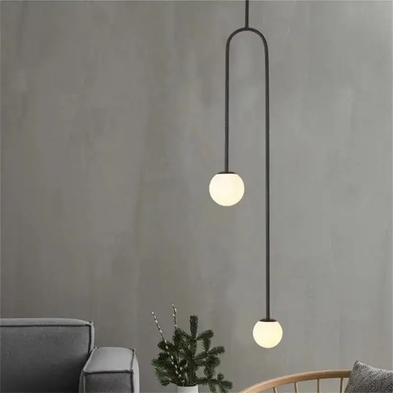 Black metal pendant light with two spherical frosted glass globes in a gold minimalist iron chandelier decorbites black model