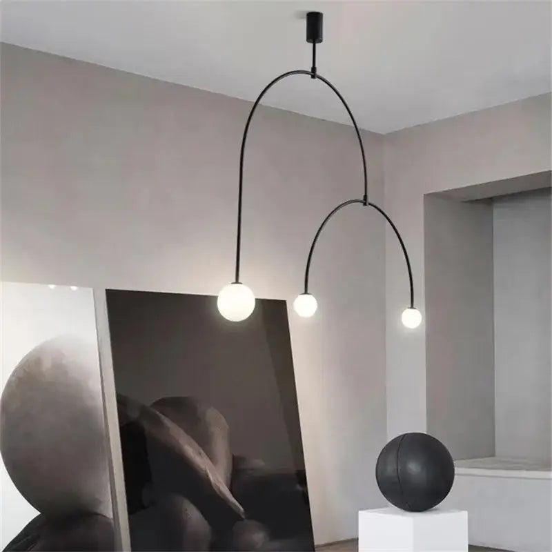Black arched pendant light with three spherical bulbs in modern gold minimalist iron chandelier for dining room decorbites black