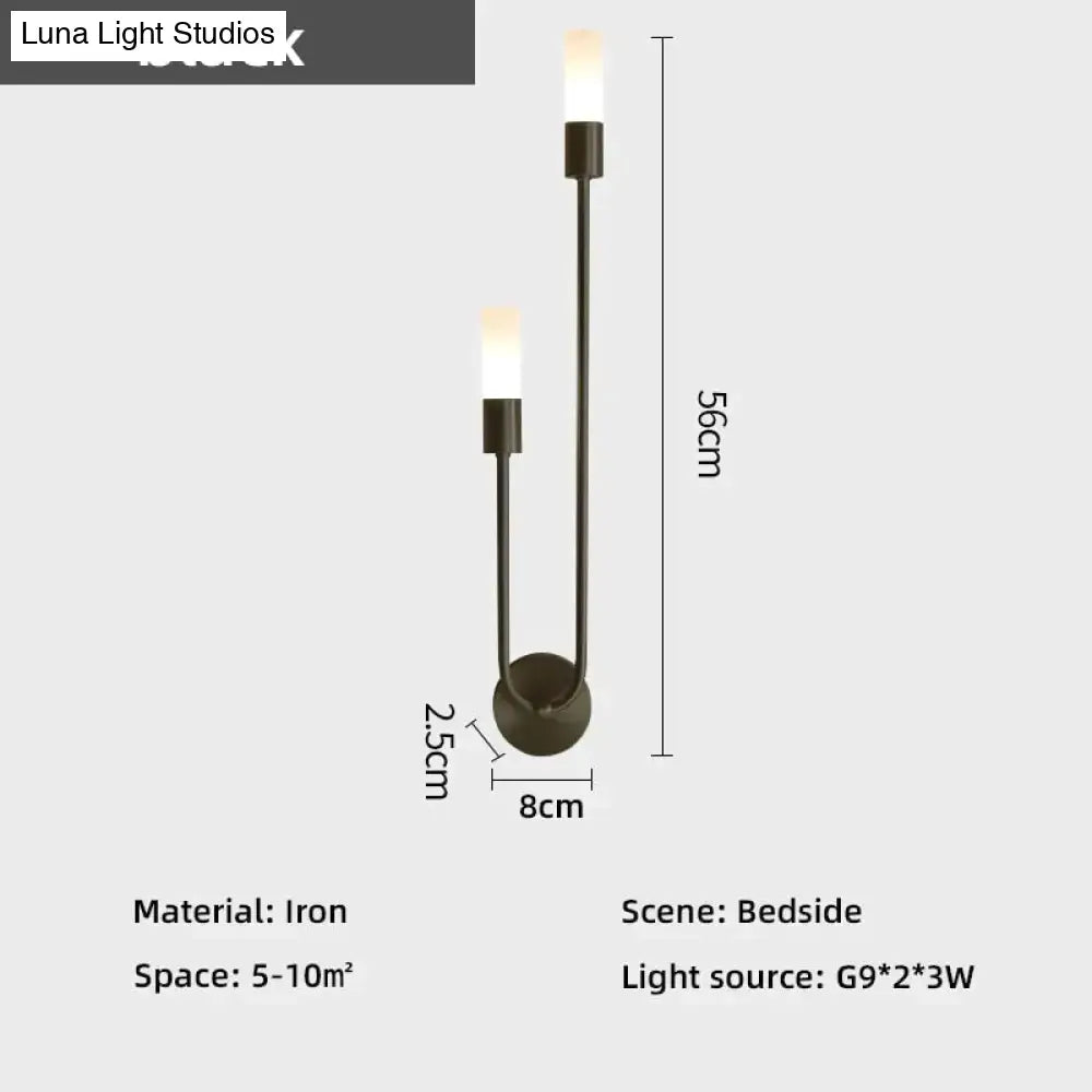 Modern black iron wall lamp featuring two upward-facing candle-style lights as a minimalist led wall lamp alternative