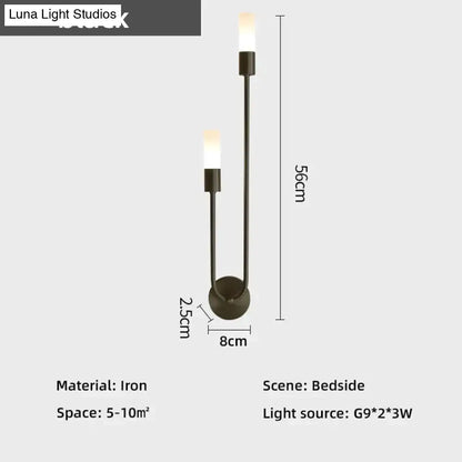 Modern black iron wall lamp featuring two upward-facing candle-style lights as a minimalist led wall lamp alternative