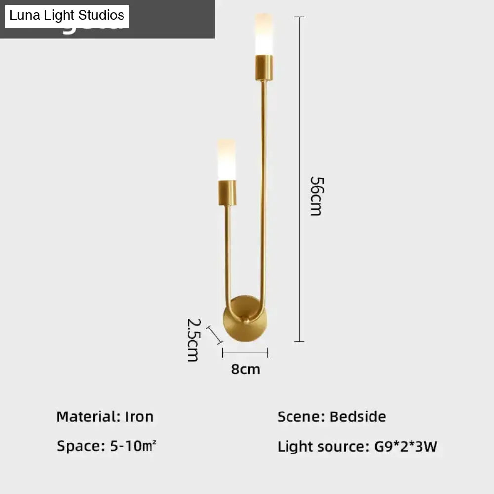 Modern gold minimalist led wall lamp with gold-toned iron frame and two upward-facing cylindrical lights for bedroom use
