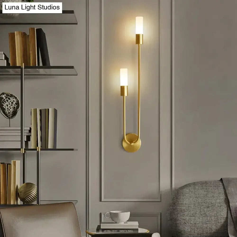 Modern gold minimalist led wall lamp with two vertical candle-style bulbs and sleek curved metal design wall sconce