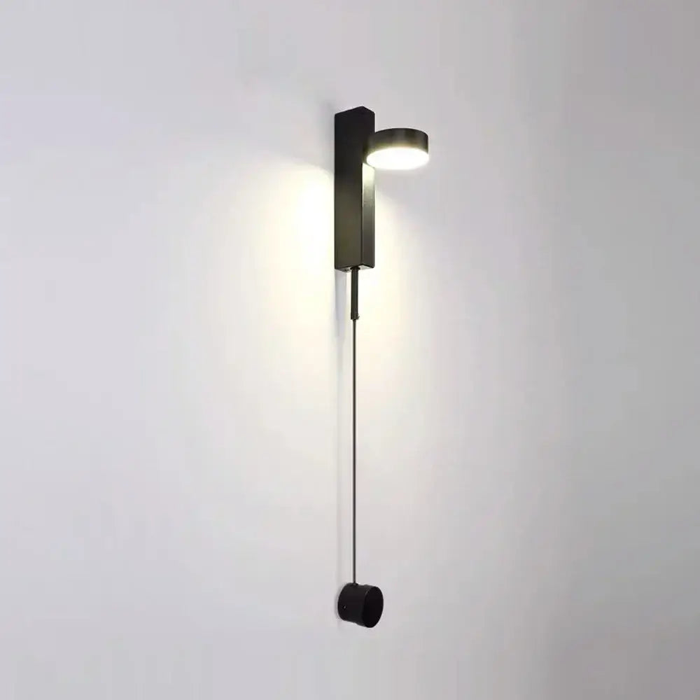 Modern gold minimalist led wall lamp with a black rectangular base and circular light head with pull cord for living room