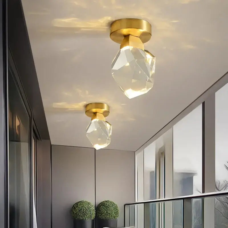 Modern gold minimalist led wall lamp featuring gold-finished ceiling-mounted fixtures with crystal-clear glass shades