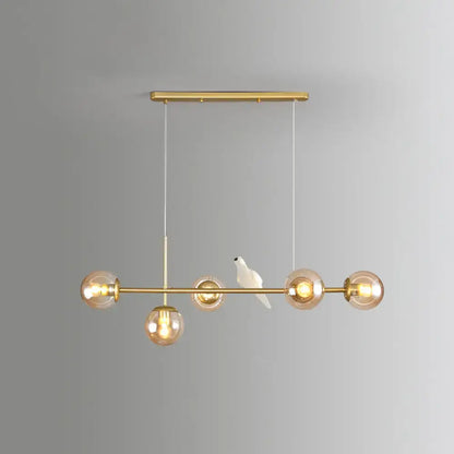 Modo island gold-toned 5-light pendant light with amber glass bulbs and milk white ceramic bird for restaurants