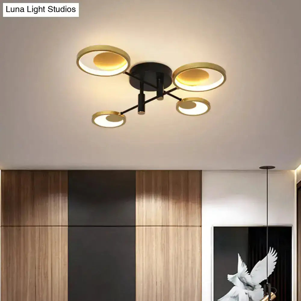 Modern black and gold molecule ceiling mount chandelier with four illuminated rings for stylish living room lighting