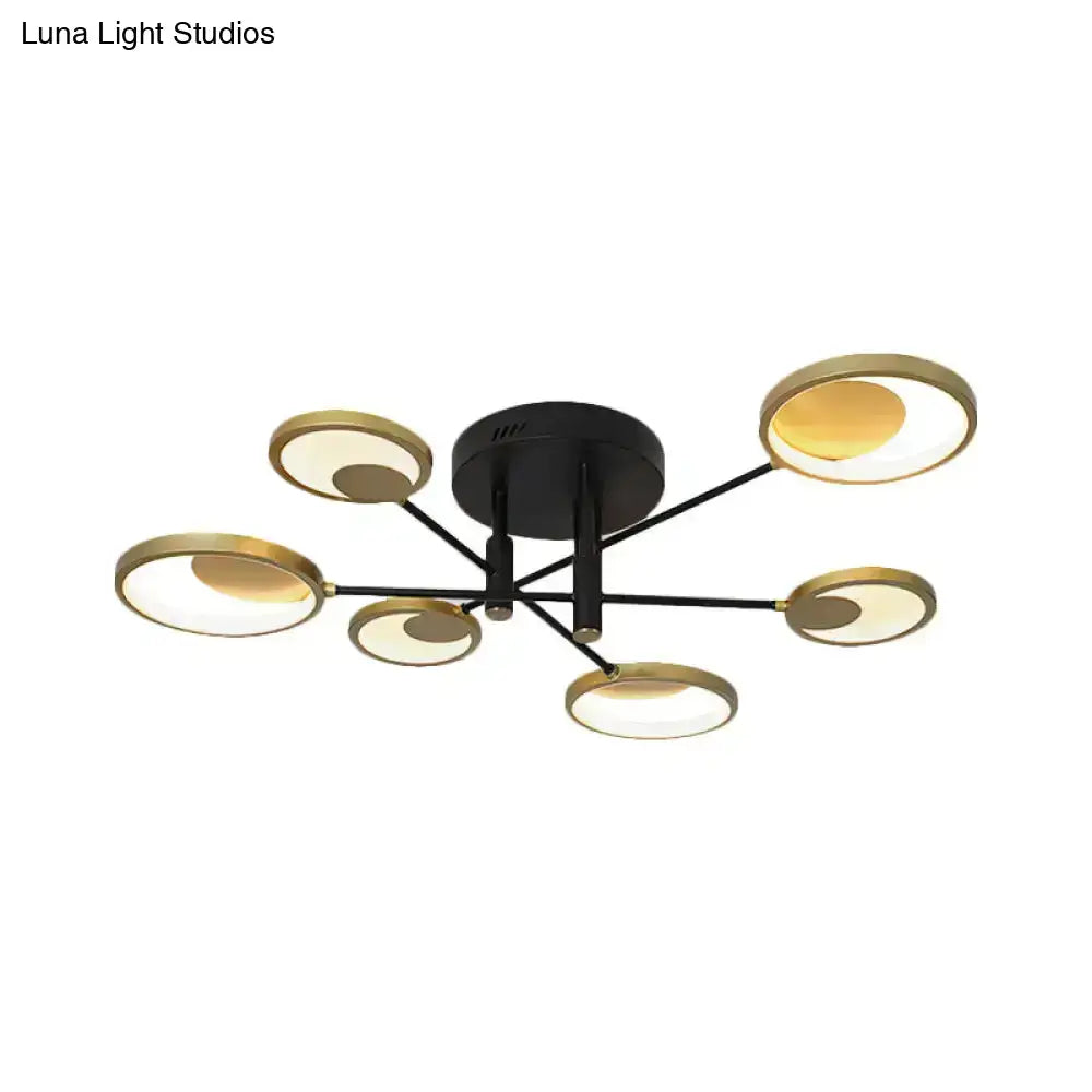 Modern black and gold molecule ceiling mount chandelier with six circular illuminated fixtures in a starburst pattern