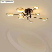 Modern gold molecule ceiling mount chandelier with eight gold-rimmed bulbs in starburst pattern on black arms for living room