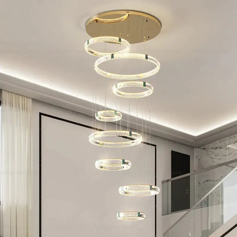 A modern gold multi tier duplex crystal chandelier with cascading crystal rings for living room