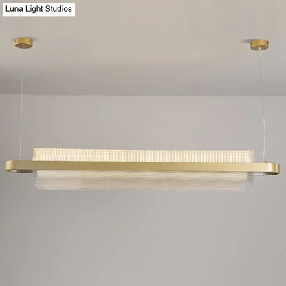 Modern gold-toned nordic linear island lamp with textured acrylic diffuser and sleek metallic frame for dining room lighting