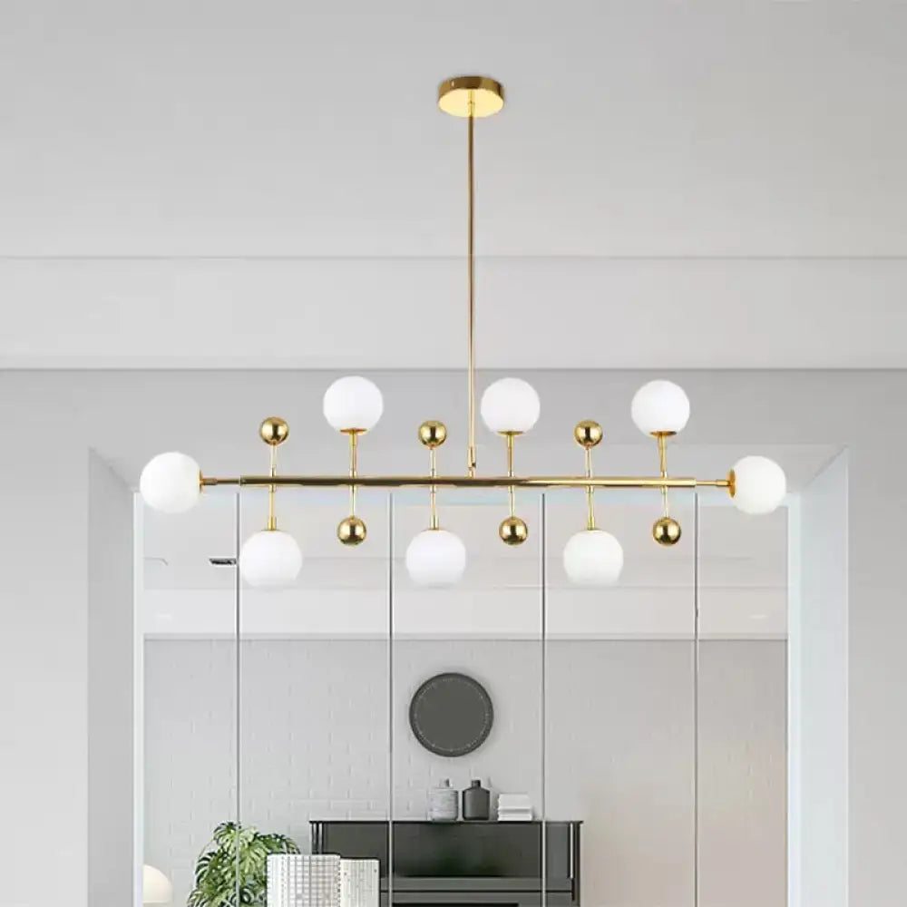 Modern gold hotel ceiling pendant with opal glass spherical shades and fixture width featuring eight lights