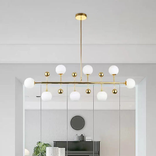 Modern gold hotel ceiling pendant with opal glass spherical shades and fixture width featuring eight lights