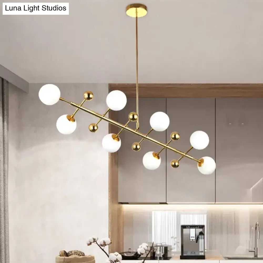 DecorBites™ modern gold ceiling pendant with 8 opal glass globes and fixture width suitable for hotel spaces