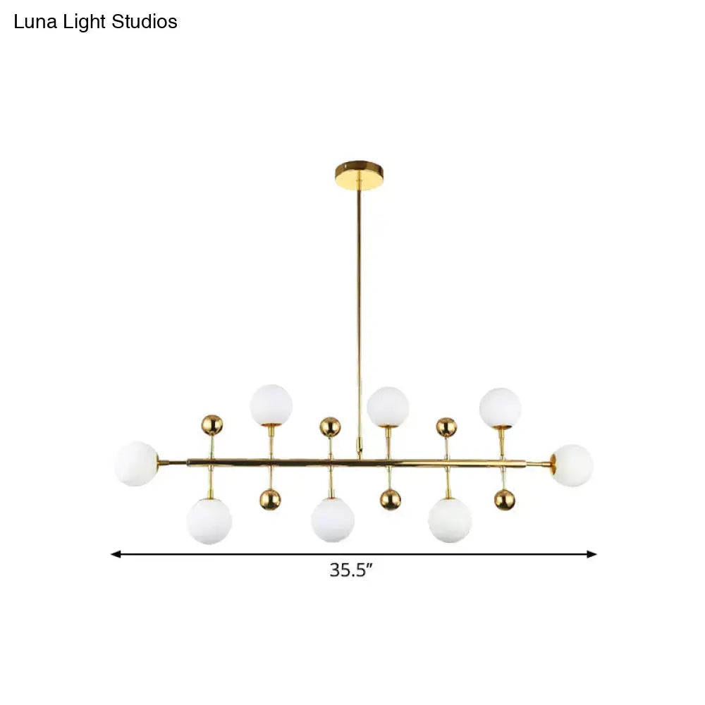 DecorBites™ modern gold ceiling pendant with seven opal glass globe shades and spherical brass accents fixture width