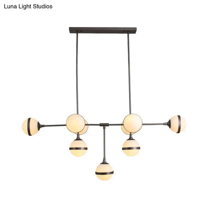 Modern black metal orb chandelier with six frosted glass globe shades and silver gold finish bulb base for restaurants and hotels