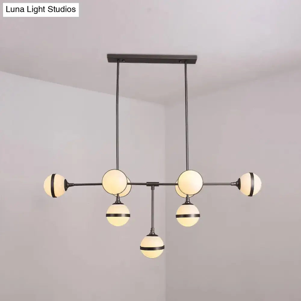 Modern black metal orb chandelier with six frosted glass globes and silver gold bulb base perfect for restaurants and hotels