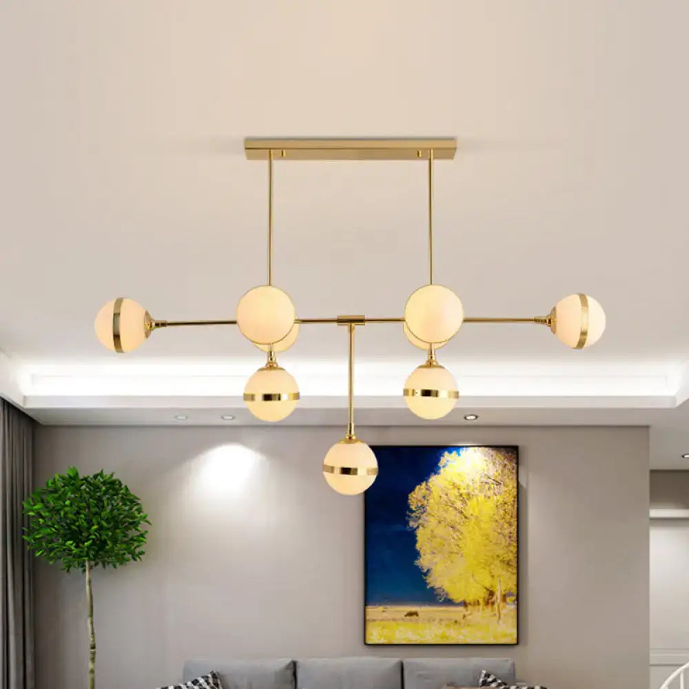 Modern DecorBites™ orb chandelier with six frosted glass globes and silver gold finish bulb base for hotel lighting