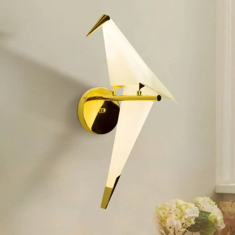 Modern gold origami bird led wall sconce with white translucent wings and pointed beak for bedroom lighting fixture