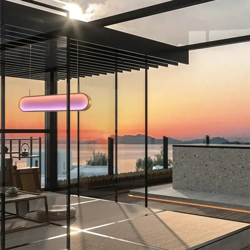 A modern gold oval decorbites led sunset chandelier with a pink and purple gradient glow for dining room lighting