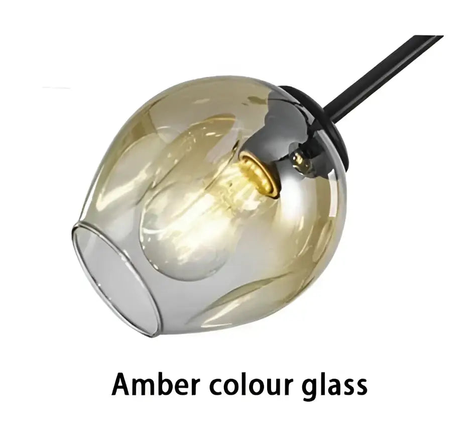 Modern amber-colored glass pendant light with sleek rounded globe and black painted metal finish for dining room