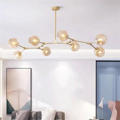 Modern gold painted metal pendant light with multiple spherical glass shades for dining room metal finish