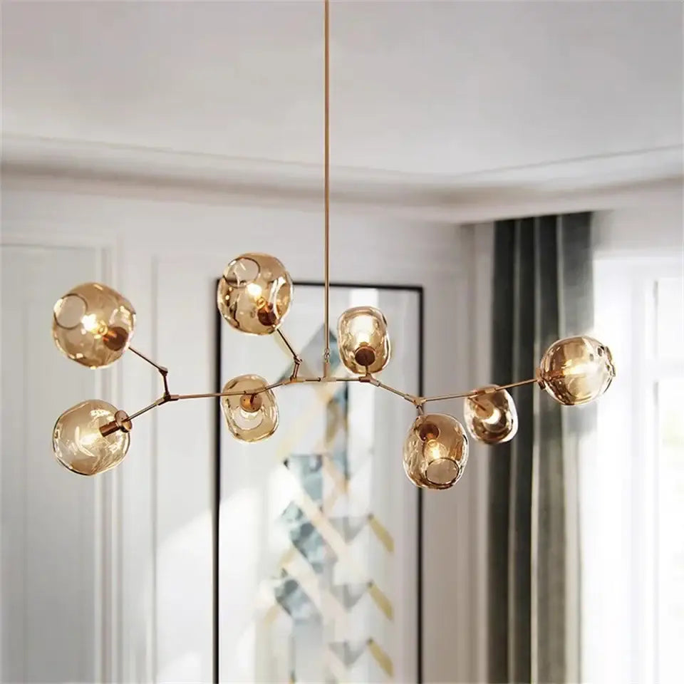 Modern gold painted metal pendant light with multiple glass globes in a branching design for dining room use