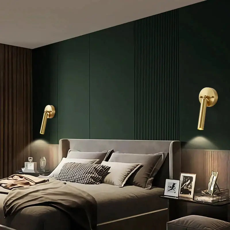 Modern gold pendant and wall sconce set featuring sleek cylindrical gold-toned wall sconces with minimalist design