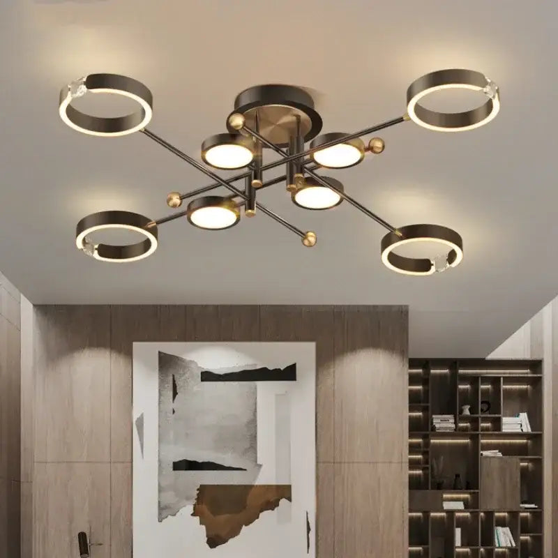 Modern black and brass-toned decorbites gold plated chandelier with circular rings and spherical accents for living room decor