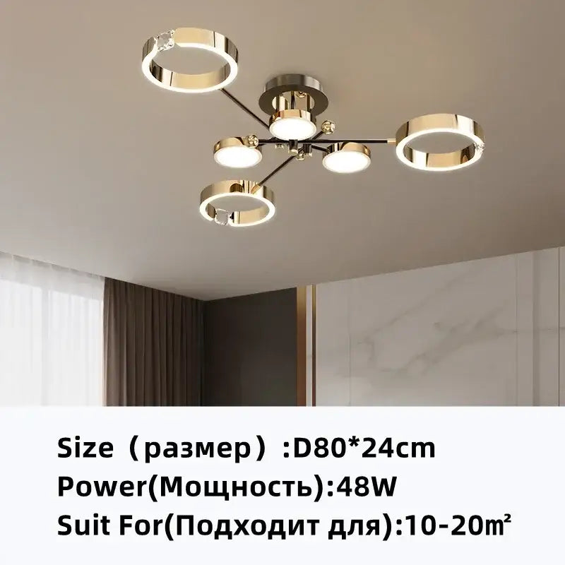 Modern gold plated chandelier with black arms featuring five circular gold rings and soft white light by decorbites gold plated