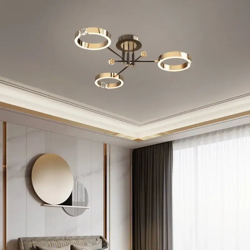 Modern gold plated chandelier with black arms featuring a gold toned ceiling light fixture by decorbites gold plated