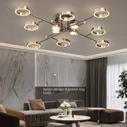 Modern gold plated chandelier with sleek black arms and circular ring lights for living room decorbites gold plated design