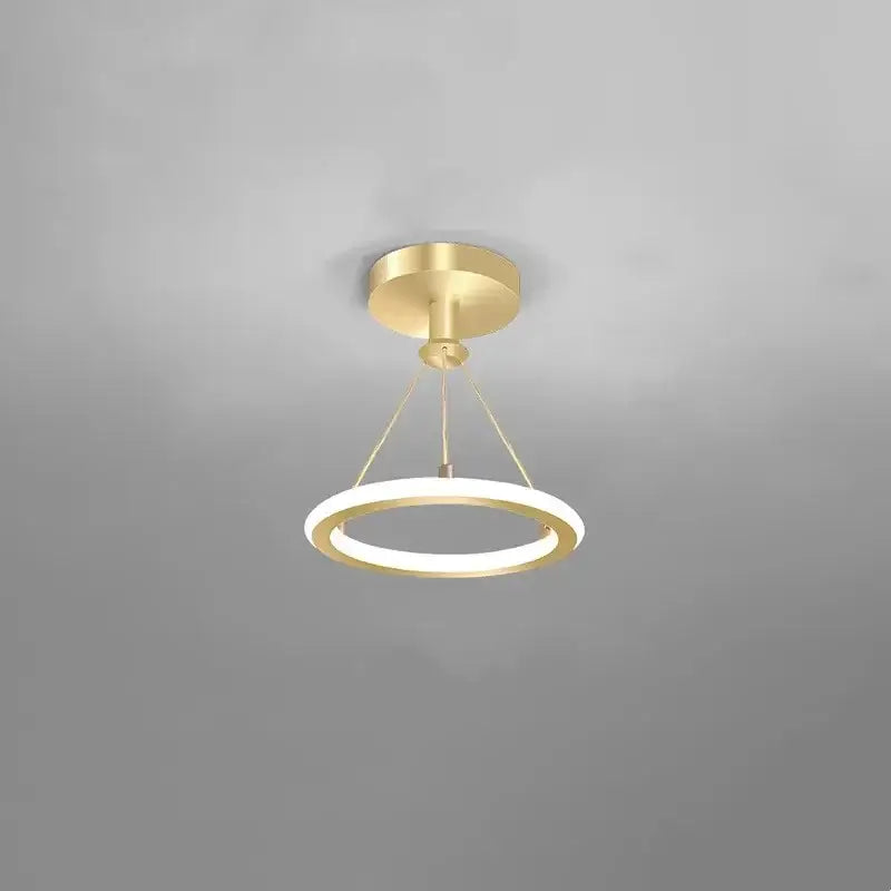 Modern decorbites gold plated chandelier with black arms featuring a gold-toned circular illuminated pendant light