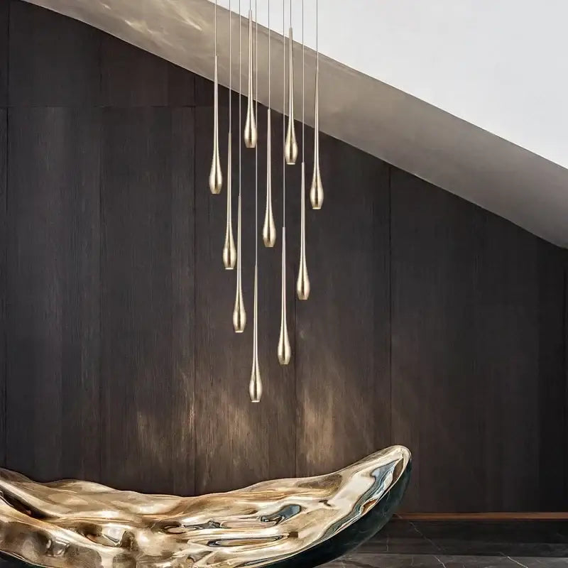 A modern gold-plated chandelier with slender teardrop pendants, perfect for living room decorbites gold-plated modern lighting