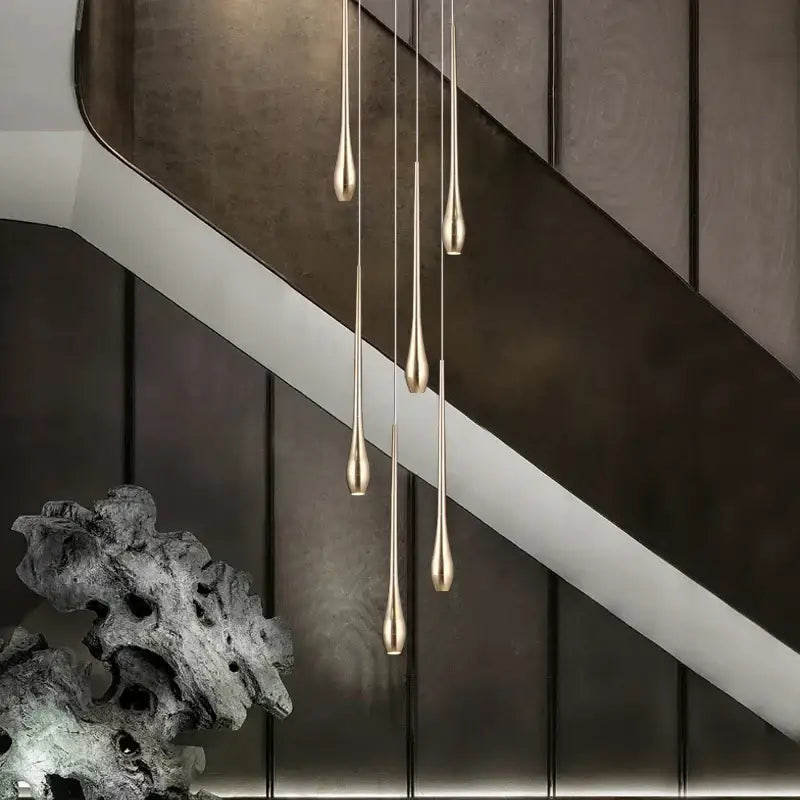 Five slender teardrop-shaped gold-plated led chandelier pendant lights with brushed finish for modern living room decorbites