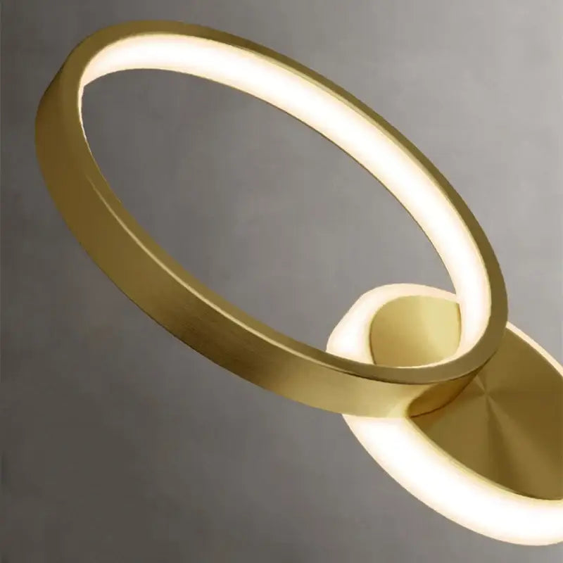 Modern gold plated three disc led wall lamp with sleek minimalist ring-shaped design perfect for bedroom decorbites gold plated