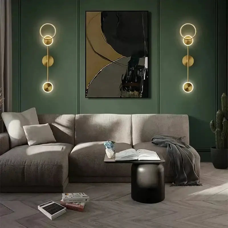 Modern gold plated wall lamp with three circular discs featuring a minimalist design for bedroom decorbites gold plated style