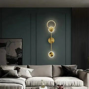 Modern gold plated wall lamp with three circular LED discs stacked vertically for elegant bedroom lighting decorbites gold plated