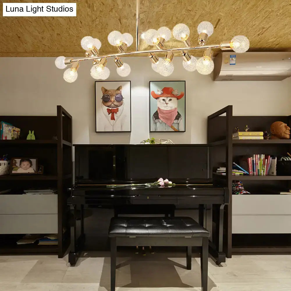 Black grand piano with glossy finish and matching bench beneath a decorbites gold prismatic glass ceiling light with bulb base