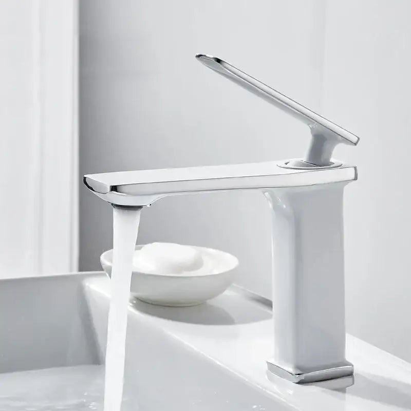Modern chrome-finished basin faucet with sleek minimalist design and rectangular spout in decorbites brass basin style