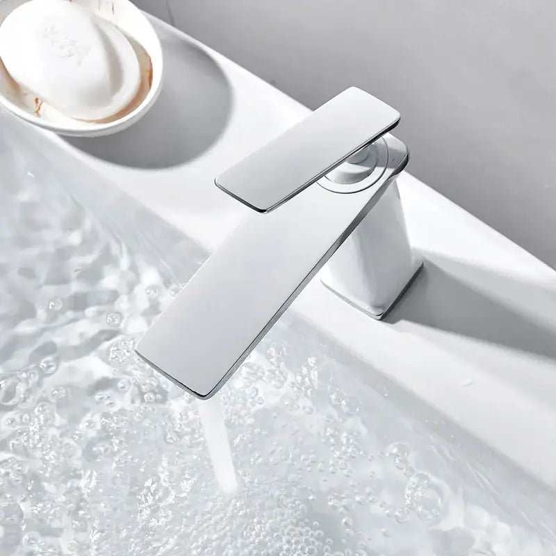 Modern chrome-finished basin faucet with sleek rectangular spout and handle, ideal for decorbites brass basin use
