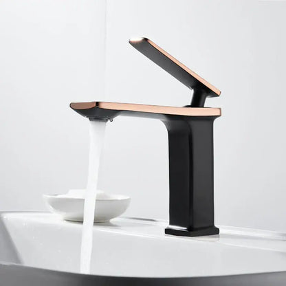 Modern gold rectangular brass basin faucet with a two-tone black base and rose gold decorbites brass basin accents